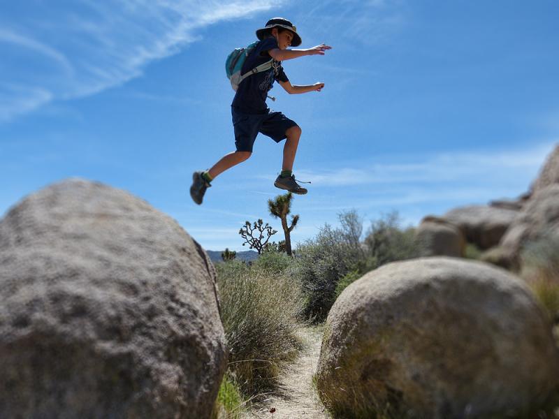 Simon jumping rocks in Joshua Tree National Park.