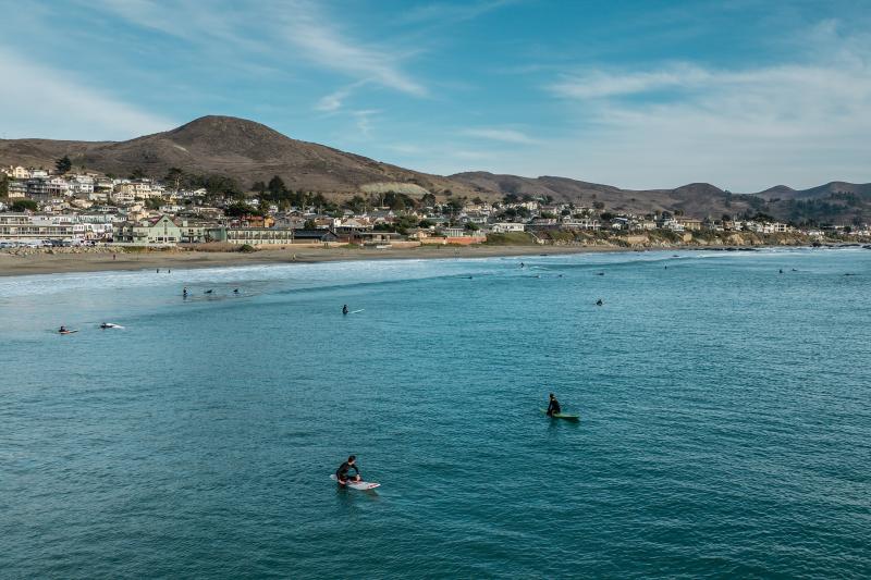 Surfing by the Cayucos pier